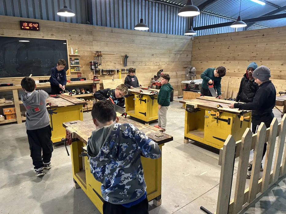 The Prowell WoodSkills woodworking studio in Paarl, with workbenches and students